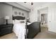 Comfortable bedroom boasts neutral colors, decorative wall art, and an en-suite bathroom at 1101 Juniper Ne St # 1216, Atlanta, GA 30309