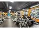 Fully equipped gym with treadmills, bikes, and weight machines, set against a bright yellow wall for an energizing workout at 1101 Juniper Ne St # 1216, Atlanta, GA 30309