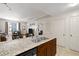 Kitchen island with granite countertops and stainless steel sink and adjacent open-concept living area at 1101 Juniper Ne St # 1216, Atlanta, GA 30309