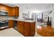 Modern kitchen with stainless steel appliances, wood cabinets, and granite countertops open to the living area at 1101 Juniper Ne St # 1216, Atlanta, GA 30309