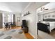 Open living room featuring hardwood floors, dining area, and media center with a view of the bedroom at 1101 Juniper Ne St # 1216, Atlanta, GA 30309