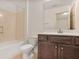The bathroom has a tub, toilet, and modern vanity with storage at 1585 Oak Meadows Ln, Cumming, GA 30041