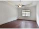 Bright bedroom featuring hardwood floors, a ceiling fan, and a large window, perfect for relaxation at 1585 Oak Meadows Ln, Cumming, GA 30041
