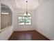 Bright dining room featuring hardwood floors, a stylish chandelier and large window providing ample natural light at 1585 Oak Meadows Ln, Cumming, GA 30041