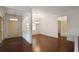 Open dining room featuring hardwood floors, a tray ceiling, and access to kitchen at 1585 Oak Meadows Ln, Cumming, GA 30041