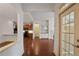 Open-concept entryway with hardwood floors, leading to a kitchen and open living space at 1585 Oak Meadows Ln, Cumming, GA 30041