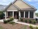 Inviting single-story home with a quaint front porch, mature landscaping, and beautiful brick facade at 1585 Oak Meadows Ln, Cumming, GA 30041
