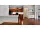 Open-concept kitchen with an island, stainless steel appliances, and hardwood floors throughout at 1585 Oak Meadows Ln, Cumming, GA 30041