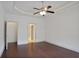 Spacious bedroom with ceiling fan, hardwood floors, and multiple doorways for convenient access at 1585 Oak Meadows Ln, Cumming, GA 30041