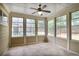 Bright sunroom filled with natural light, featuring neutral paint, tiled floor, and multiple large windows at 1585 Oak Meadows Ln, Cumming, GA 30041