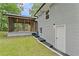 Exterior view of the backyard featuring a brick home, screen porch, and access to the basement at 3034 Barksdale Cir, Atlanta, GA 30344
