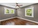 Inviting bedroom featuring hardwood floors, neutral paint, recessed lighting, and natural light from two windows at 3034 Barksdale Cir, Atlanta, GA 30344