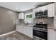 Modern kitchen boasts white cabinets, granite countertops, stainless steel appliances, and stylish backsplash at 3034 Barksdale Cir, Atlanta, GA 30344