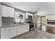 Bright kitchen featuring sleek appliances, decorative tile backsplash, and seamless flow into the adjacent living space at 3034 Barksdale Cir, Atlanta, GA 30344