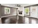 Bright living room featuring hardwood floors, a cozy fireplace, and abundant natural light from large windows at 3034 Barksdale Cir, Atlanta, GA 30344