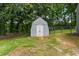 A well-maintained shed with double doors in a fenced backyard at 3034 Barksdale Cir, Atlanta, GA 30344