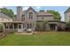 Lovely backyard featuring a patio with table, a screened-in porch, and lush lawn at 4218 Sandy Branch Dr, Buford, GA 30519