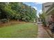 Spacious backyard with retaining wall, mature trees, and a charming outdoor setting at 4218 Sandy Branch Dr, Buford, GA 30519