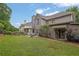 Beautiful backyard with lush grass, patio, screened porch, and mature trees at 4218 Sandy Branch Dr, Buford, GA 30519