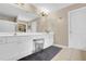 Bright bathroom with double vanity, white cabinets, and vanity stool at 4218 Sandy Branch Dr, Buford, GA 30519