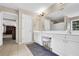 Bright bathroom featuring double sinks, vanity, and tile flooring at 4218 Sandy Branch Dr, Buford, GA 30519