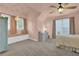 Bedroom features carpet, light pink walls, two windows, curtains and stylish furniture at 4218 Sandy Branch Dr, Buford, GA 30519