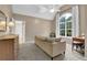 Bedroom with carpet, beige walls, a tall window, comfortable couch and wooden desk at 4218 Sandy Branch Dr, Buford, GA 30519