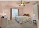 This bedroom features carpet, an exterior window, a ceiling fan and a metal frame bed at 4218 Sandy Branch Dr, Buford, GA 30519