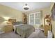 Comfortable bedroom with yellow walls, carpet, large window and wooden furniture at 4218 Sandy Branch Dr, Buford, GA 30519