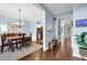 Open-concept dining room featuring hardwood floors and light blue walls at 4218 Sandy Branch Dr, Buford, GA 30519