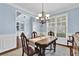 Charming dining room featuring a wood table, decorative chandelier, and soft blue walls at 4218 Sandy Branch Dr, Buford, GA 30519