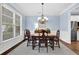 Traditional dining room with hardwood floors, a classic chandelier, and natural light at 4218 Sandy Branch Dr, Buford, GA 30519