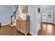 Inviting entryway with hardwood floors, a console table, and double doors at 4218 Sandy Branch Dr, Buford, GA 30519