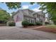 Beautiful home with two-car garage, American flag, and lush landscaping at 4218 Sandy Branch Dr, Buford, GA 30519