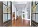 Bright foyer showcasing hardwood floors and light blue walls, leading into a spacious home at 4218 Sandy Branch Dr, Buford, GA 30519