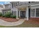 Inviting front entrance with double doors, decorative wreaths, and potted plants on a tree lined street at 4218 Sandy Branch Dr, Buford, GA 30519