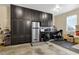 Well organized garage featuring floor to ceiling cabinets and a stainless steel refrigerator at 4218 Sandy Branch Dr, Buford, GA 30519