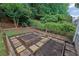 Backyard garden with raised beds, brick pathways and lush greenery at 4218 Sandy Branch Dr, Buford, GA 30519