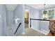 Hallway features blue walls, white railing, an ornate hanging light, and carpet floors at 4218 Sandy Branch Dr, Buford, GA 30519