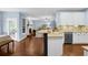 Spacious kitchen view into a living room with hardwood floors and neutral paint at 4218 Sandy Branch Dr, Buford, GA 30519