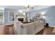 Bright living room with hardwood floors, a white fireplace and a large white sofa at 4218 Sandy Branch Dr, Buford, GA 30519
