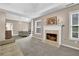Inviting living room with fireplace, large windows and neutral color palette at 4218 Sandy Branch Dr, Buford, GA 30519