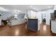 Open concept living room and kitchen with hardwood floors and neutral paint at 4218 Sandy Branch Dr, Buford, GA 30519