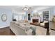 Light-filled living room features a cozy fireplace, plush seating, and hardwood floors at 4218 Sandy Branch Dr, Buford, GA 30519