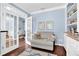 Comfortable office space with built in bookcases, a cozy sitting area, and french doors to the hallway at 4218 Sandy Branch Dr, Buford, GA 30519