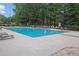 Community pool with plenty of lounge chairs for relaxing by the water at 4218 Sandy Branch Dr, Buford, GA 30519