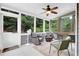 Relaxing screened porch featuring ceiling fan, cozy seating, and views of the backyard at 4218 Sandy Branch Dr, Buford, GA 30519