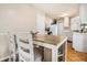 Kitchen featuring an eat-in area with table and chairs, plus white cabinets and parquet floors at 7008 Glen Valley Way, Fairburn, GA 30213