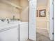 Laundry room area with washer and dryer hookups, plus shelving at 7008 Glen Valley Way, Fairburn, GA 30213