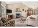 Comfortable living room featuring a fireplace, neutral paint colors, and stylish furniture at 7008 Glen Valley Way, Fairburn, GA 30213